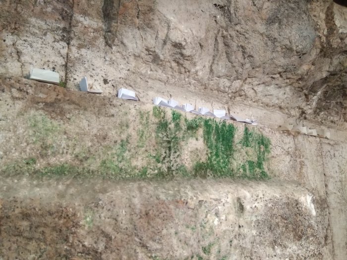 Туристы с трепетом оставляют записки в подземной части Стены Плача, пока еще редко посещаемой